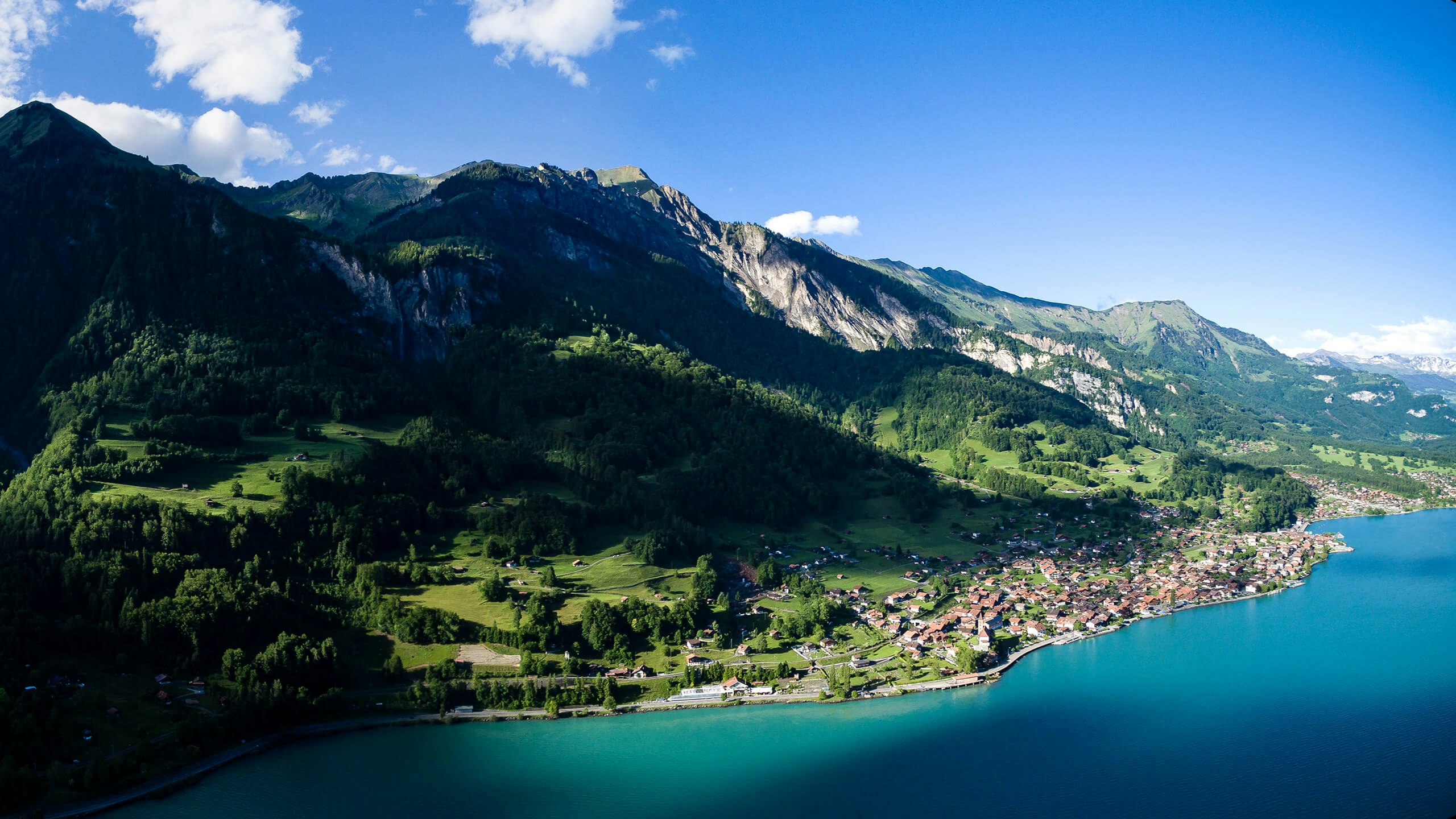 landscape photography of mountains surrounded by body of water